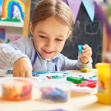 Young girl engaged in a hands-on maths and craft learning activity